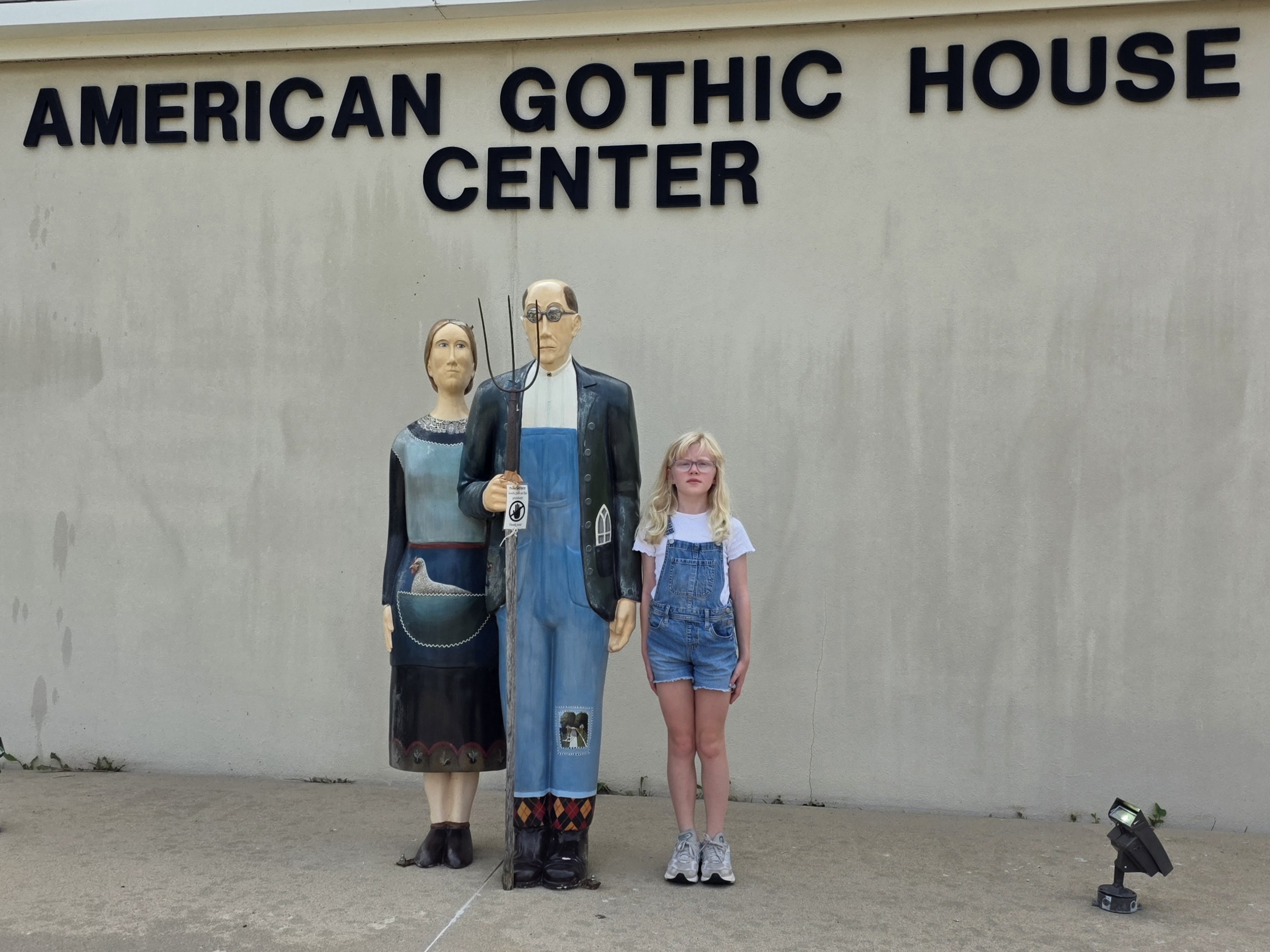 Camilla posing with statues